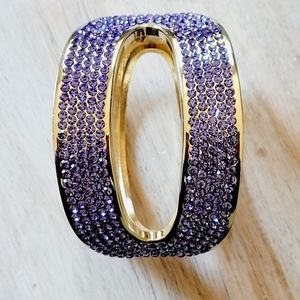 Gold toned bangle a top with 2 rows of Lavender crystals